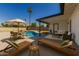Inviting backyard with pool, lounge chairs, outdoor seating, and privacy wall at 1906 N Evergreen St, Chandler, AZ 85225