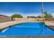 A stunning backyard pool surrounded by a gray concrete patio at 1906 N Evergreen St, Chandler, AZ 85225