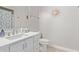 Bright bathroom featuring a white vanity, modern fixtures, and a daisy-themed shower curtain at 1914 S Brooks Cir, Mesa, AZ 85202