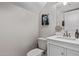 A charming powder room with a white vanity, designer faucet, and elegant decor, perfect for guests at 1914 S Brooks Cir, Mesa, AZ 85202