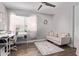 Well-lit bedroom with a neutral color palette, featuring a cozy sofa and a dedicated workspace at 1914 S Brooks Cir, Mesa, AZ 85202