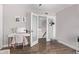 Bright bedroom features a modern desk area, light wood flooring, and a glass-paneled door at 1914 S Brooks Cir, Mesa, AZ 85202