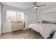 Bright bedroom featuring a cozy bed, a ceiling fan, and a dedicated workspace with a whiteboard at 1914 S Brooks Cir, Mesa, AZ 85202