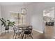 Charming dining area with a modern chandelier, neutral walls and natural light at 1914 S Brooks Cir, Mesa, AZ 85202