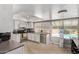 Bright kitchen featuring stainless steel appliances, white cabinets, and views of the pool at 1914 S Brooks Cir, Mesa, AZ 85202