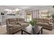 Relaxing living room with comfortable reclining sofas, sliding glass doors to the pool, and views of the backyard at 1914 S Brooks Cir, Mesa, AZ 85202