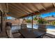 Covered patio with outdoor seating and a view of the sparkling swimming pool at 1914 S Brooks Cir, Mesa, AZ 85202