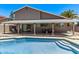 Backyard view of pool and covered patio with seating and a dining area perfect for entertaining at 1914 S Brooks Cir, Mesa, AZ 85202