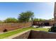 Beautiful backyard with artificial grass and a stone-paved patio offering a great outdoor space at 2023 W Yellowbird Ln, Phoenix, AZ 85085