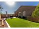 Expansive backyard featuring well-maintained artificial grass and cozy patio area, perfect for outdoor activities at 2023 W Yellowbird Ln, Phoenix, AZ 85085