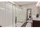 Bathroom featuring a large walk-in shower with a glass enclosure, a vanity, and wood look tile flooring at 2023 W Yellowbird Ln, Phoenix, AZ 85085