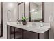 A bathroom featuring a dual vanity with a white countertop and dark wood cabinets at 2023 W Yellowbird Ln, Phoenix, AZ 85085