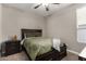 Cozy bedroom with a queen bed, dark furniture, and a ceiling fan at 2023 W Yellowbird Ln, Phoenix, AZ 85085