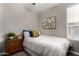 Bright bedroom with a single bed, natural light, and wooden nightstand at 2023 W Yellowbird Ln, Phoenix, AZ 85085