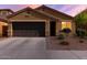 Charming single-story home with a well-manicured front yard, driveway, and a two-car garage at 2023 W Yellowbird Ln, Phoenix, AZ 85085