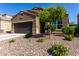 Single-story home featuring desert landscaping with vibrant plants and a two-car garage at 2023 W Yellowbird Ln, Phoenix, AZ 85085