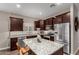 Spacious kitchen features granite countertops, stainless steel appliances, and a center island at 2023 W Yellowbird Ln, Phoenix, AZ 85085