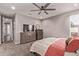 This main bedroom has carpet, a ceiling fan, and a media center with a TV and mirror at 2023 W Yellowbird Ln, Phoenix, AZ 85085
