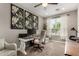 Comfortable home office with neutral colors, carpet flooring, and decorative floral artwork at 2023 W Yellowbird Ln, Phoenix, AZ 85085