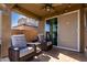 Cozy covered patio with comfortable seating, a ceiling fan, and sliding glass doors leading indoors at 2023 W Yellowbird Ln, Phoenix, AZ 85085