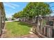 Expansive backyard featuring lush green lawn, mature trees, and a refreshing swimming pool in a private setting at 2125 E Elmwood St, Mesa, AZ 85213