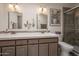 Well-lit bathroom featuring a double sink vanity, a tile countertop, and a glass-enclosed walk-in shower at 2125 E Elmwood St, Mesa, AZ 85213