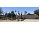 Charming single-story home featuring desert landscaping, an arched entryway, and a two-car garage at 2125 E Elmwood St, Mesa, AZ 85213