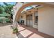 Charming front porch with a brick floor, stone supports, and a decorative archway for an inviting entrance at 2125 E Elmwood St, Mesa, AZ 85213