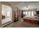 Spacious main bedroom featuring carpet, a full-length mirror, and double glass doors for backyard access at 2125 E Elmwood St, Mesa, AZ 85213