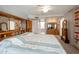 Bright main bedroom with ample built-in storage, a large bed, and a view of the ensuite bathroom at 2125 E Elmwood St, Mesa, AZ 85213