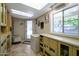 Organized utility room with ample cabinetry, a countertop work area, and a convenient exterior door at 2125 E Elmwood St, Mesa, AZ 85213