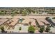 Aerial view of tan-roofed homes with well-kept landscaping and desert landscaping at 21284 E Camacho Rd, Queen Creek, AZ 85142