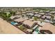 Drone-eye view of homes with a community pool, landscaped yards, and desert landscaping at 21284 E Camacho Rd, Queen Creek, AZ 85142