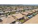An aerial shot showing a tan-roofed home with a pool and neighboring houses at 21284 E Camacho Rd, Queen Creek, AZ 85142