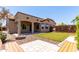 Landscaped backyard with artificial lawn and firepit sitting area at 21284 E Camacho Rd, Queen Creek, AZ 85142