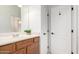 Bathroom with a wood vanity and a white door at 21284 E Camacho Rd, Queen Creek, AZ 85142