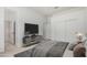 Bright bedroom with a ceiling fan, a closet with double doors, and adjacent bathroom access at 21284 E Camacho Rd, Queen Creek, AZ 85142
