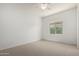 This large room features neutral walls and carpet, and a nice window at 21284 E Camacho Rd, Queen Creek, AZ 85142