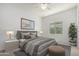 Comfortable bedroom featuring soft natural light, stylish decor and a modern ceiling fan at 21284 E Camacho Rd, Queen Creek, AZ 85142