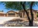 Attractive desert home featuring a three-car garage, neutral stucco, tile roof, and desert landscaping at 21284 E Camacho Rd, Queen Creek, AZ 85142