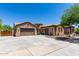 Single Gathering home with a three-car garage, neutral colored stucco, tile roof, and desert landscaping at 21284 E Camacho Rd, Queen Creek, AZ 85142