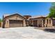 Beautiful single Gathering home with a three-car garage, neutral colored stucco, tile roof, and desert landscaping at 21284 E Camacho Rd, Queen Creek, AZ 85142