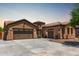 Beautiful single Gathering home with a three-car garage, neutral colored stucco, tile roof, and desert landscaping at 21284 E Camacho Rd, Queen Creek, AZ 85142