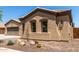 Close-up of house showing stucco, desert landscaping, and dual-pane windows at 21284 E Camacho Rd, Queen Creek, AZ 85142