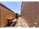 Narrow side yard with gravel, flagstone, block wall, and sitting benches at 21284 E Camacho Rd, Queen Creek, AZ 85142