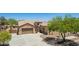 Inviting single-Gathering home with a three-car garage, desert landscaping, and a covered patio in a sunny neighborhood at 21284 E Camacho Rd, Queen Creek, AZ 85142