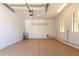 This garage features an epoxy floor, overhead storage, and a utility sink at 21284 E Camacho Rd, Queen Creek, AZ 85142