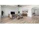 Spacious living room with modern furnishings and light wood flooring, creating an inviting atmosphere at 21284 E Camacho Rd, Queen Creek, AZ 85142