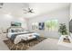 Beautifully designed main bedroom featuring a ceiling fan, artwork, and lots of natural light at 21284 E Camacho Rd, Queen Creek, AZ 85142
