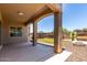 Covered patio with ample outdoor seating, a fire pit, and a view of the desert landscaping at 21284 E Camacho Rd, Queen Creek, AZ 85142